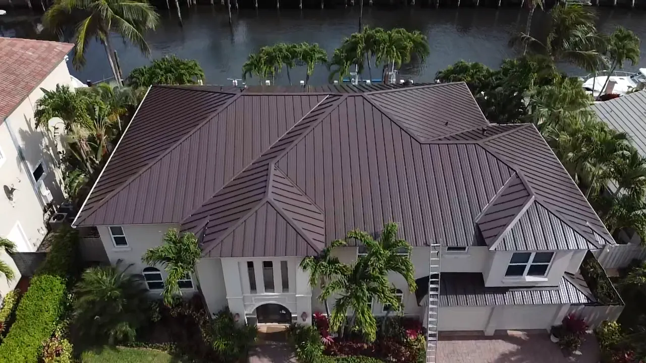 Aerial view of a brown standing-seam roof on a waterfront home